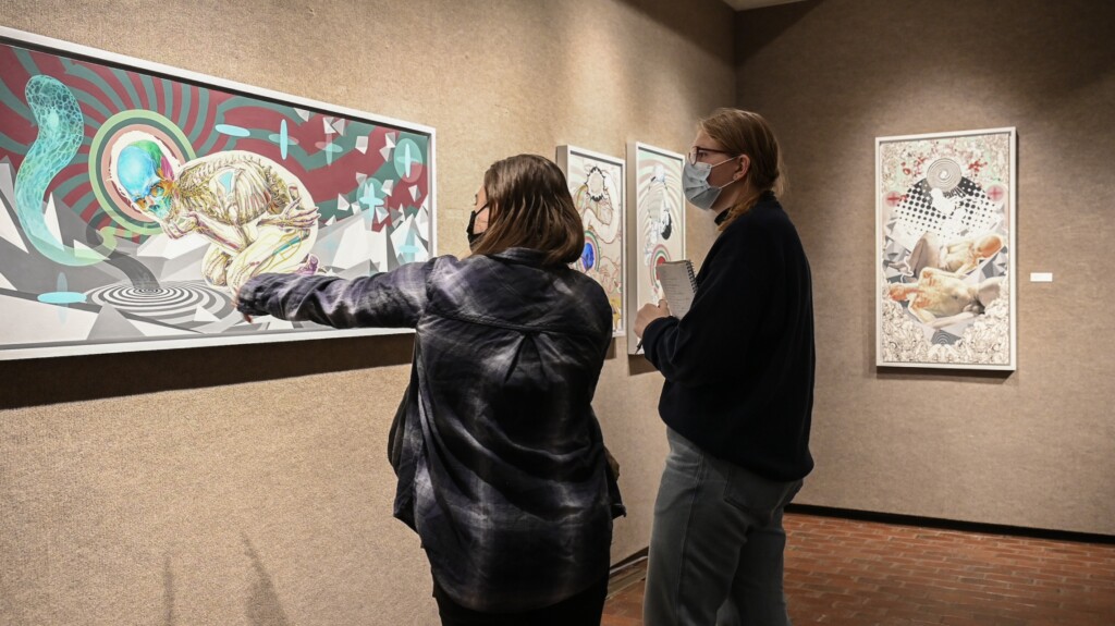 Students examine artworks in the Doris Ulmann Galleries.