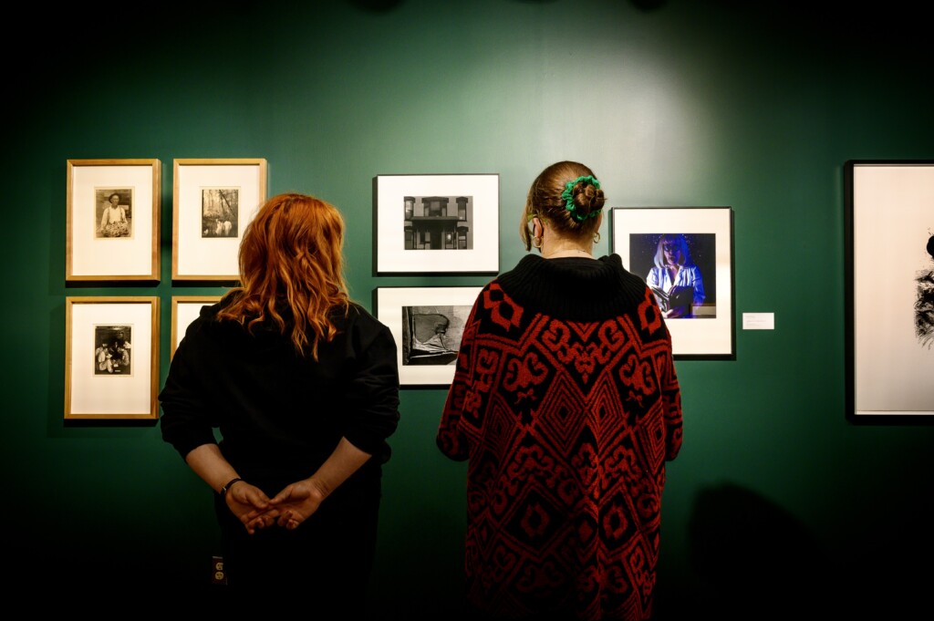 Students examine artworks in the Doris Ulmann Galleries.