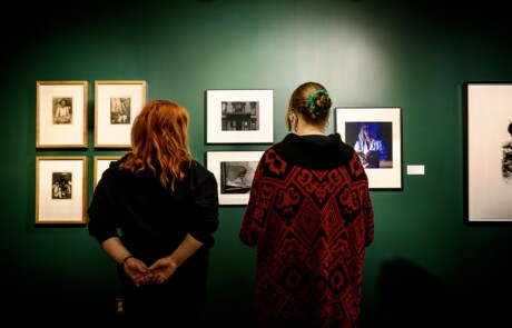Students examine artworks in the Doris Ulmann Galleries.